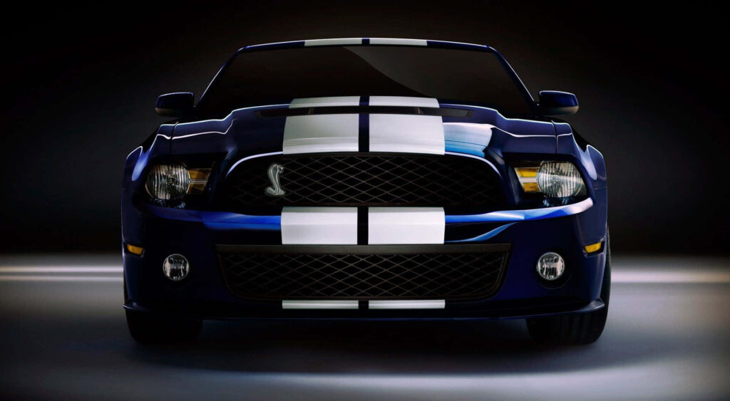 Blue sports car with white racing stripes on dark background speed thrills wallpaper design