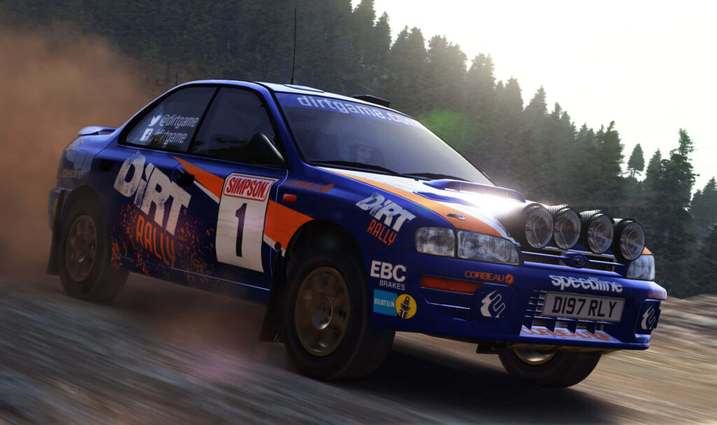 The Thrilling Speed Demon: Dirt Rally Scene with a Blue Subaru Blitzing Through a Forested Race Track Wallpaper