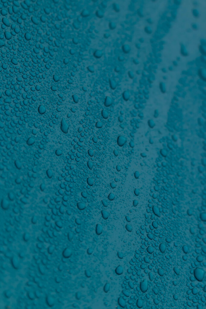 Textured Blue Surface with Water Droplets - Macro Wallpaper Background