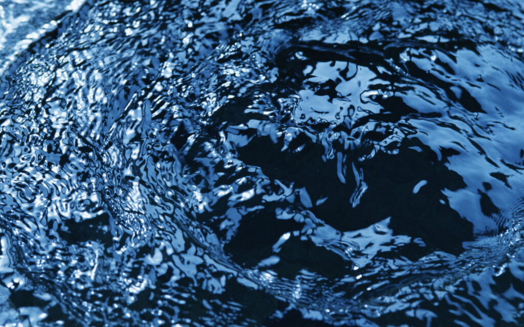 Prismatic Ripples: A Captivating Macro View of Blue Water Textures Wallpaper