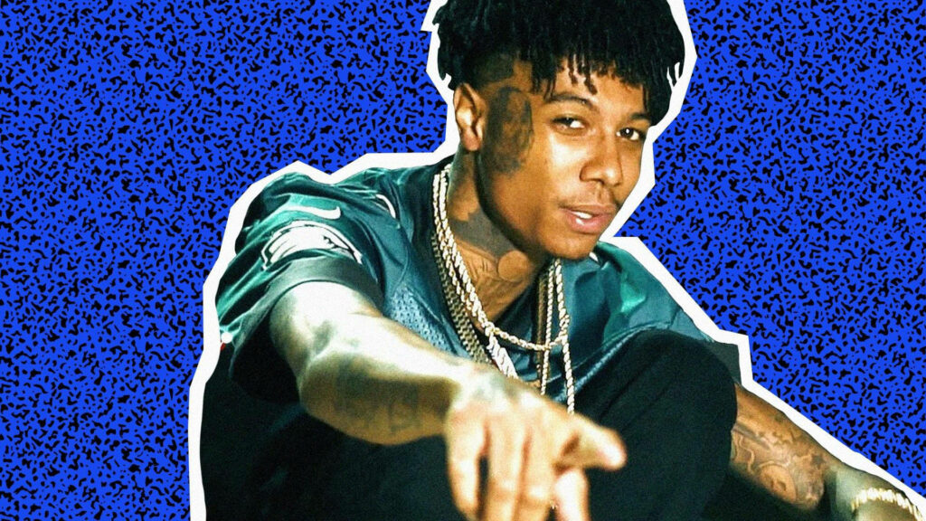 Blueface pointing at camera vibrant blue textured background dynamic hip hop wallpaper