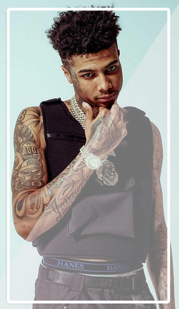 Blueface showing tattoos stylish jewelry and Hanes waistband on minimalistic wallpaper background