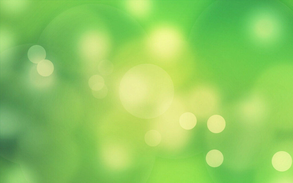 Serene green bokeh wallpaper with soft glowing circles and calming minimalist abstract background