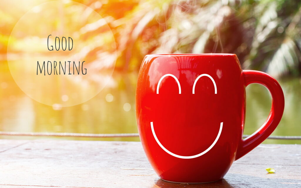 Vibrant Greetings: Captivating Artwork of a Red Cup Blurring Morning Bliss Wallpaper