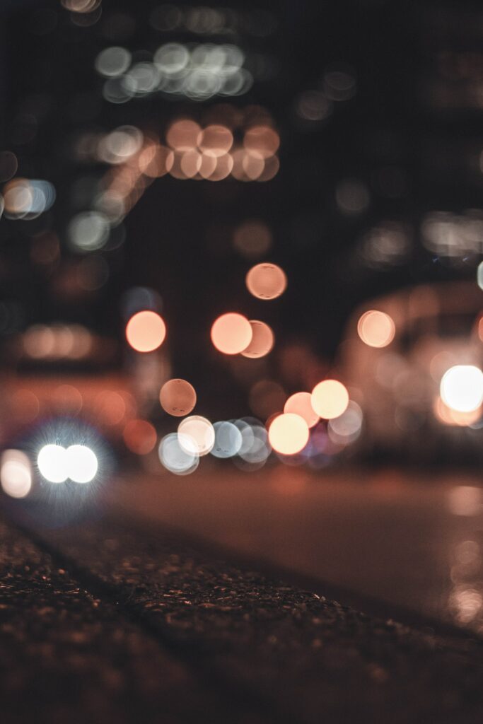 Urban Night Bokeh Wallpaper: Blurred Streets & Textured Asphalt Background