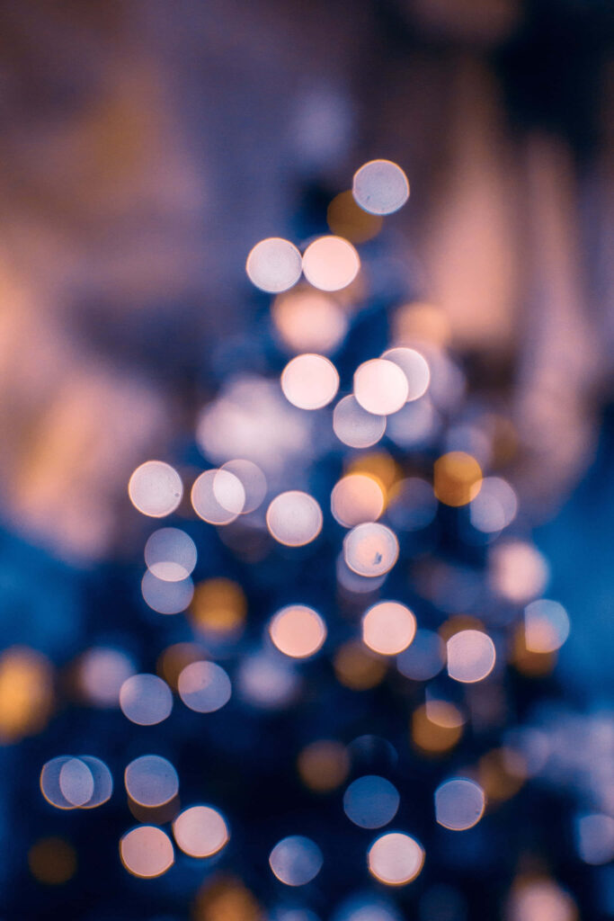 Dreamy Blurred Christmas Tree Wallpaper with Warm Bokeh Lights