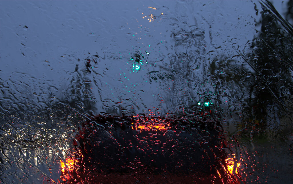 Rainy Evening Wallpaper: Blurry Wet Glass with Raindrops & Lights