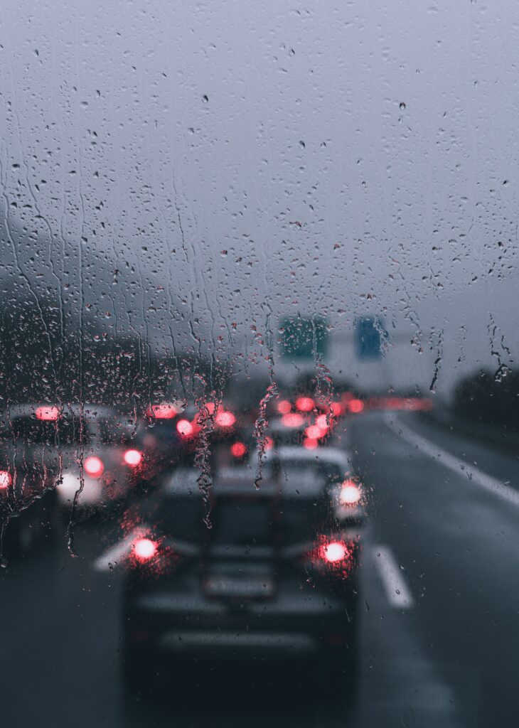 Blurry Rainy Window Scene: Dimly Lit Wallpaper Background