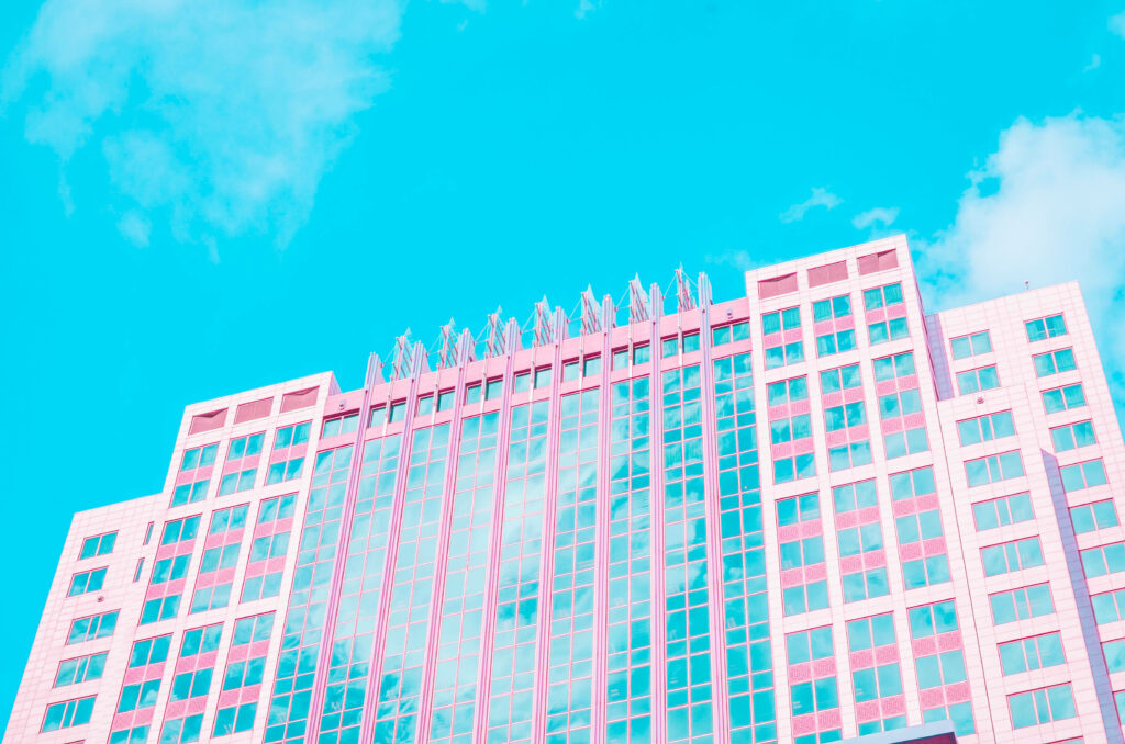 Picturesque Pink Palace: A Captivating Aesthetic Wallpaper of a Sky-Reflecting Building