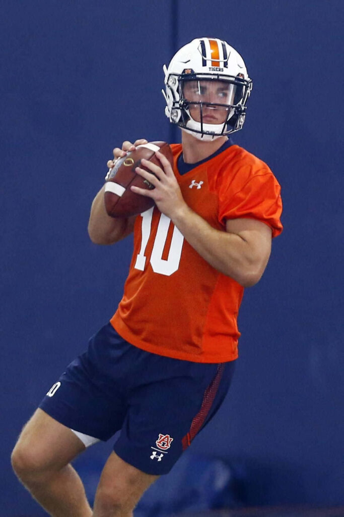 Bo Nix focused throwing football during Auburn practice quarterback action wallpaper background