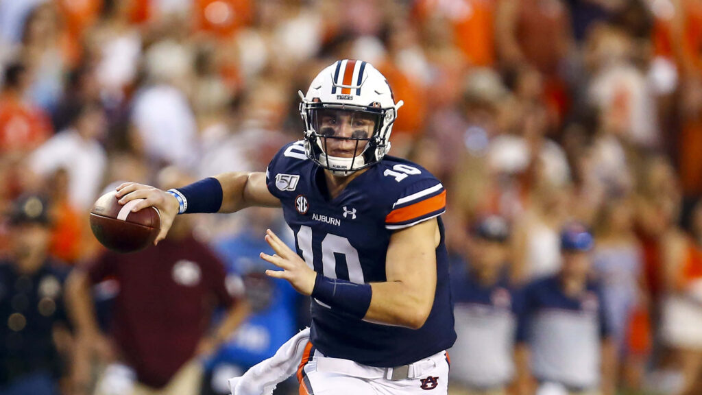 Auburn quarterback Bo Nix focused ready to throw in intense football game stadium background Wallpaper