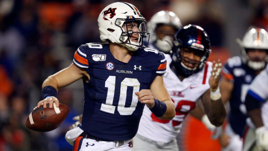 Bo Nix Auburn quarterback in uniform preparing to throw a decisive football play wallpaper background