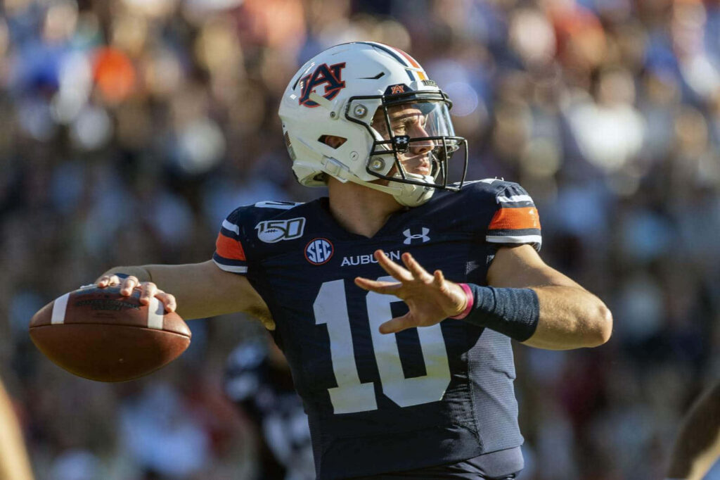 Auburn quarterback Bo Nix in action preparing to throw pass on football field wallpaper background