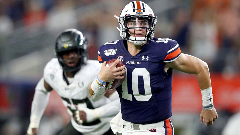Bo Nix running in Auburn uniform dynamic quarterback action football wallpaper background