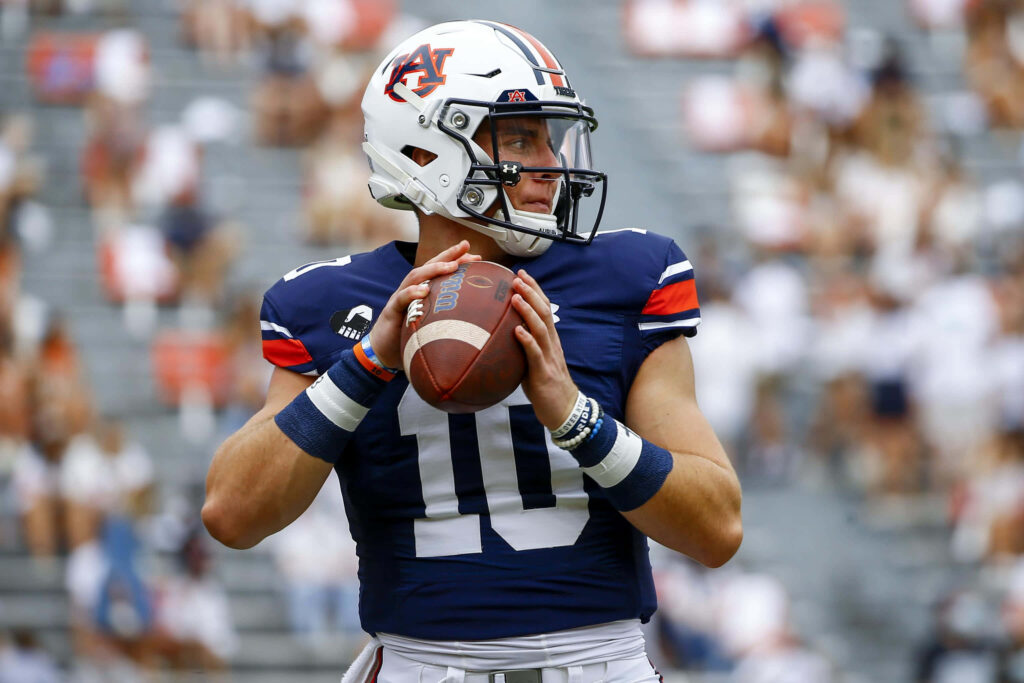 Auburn quarterback Bo Nix in team uniform focused and ready for pre-game play wallpaper background