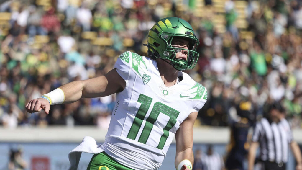Bo Nix Oregon Ducks quarterback in action intense athletic dynamic football wallpaper background