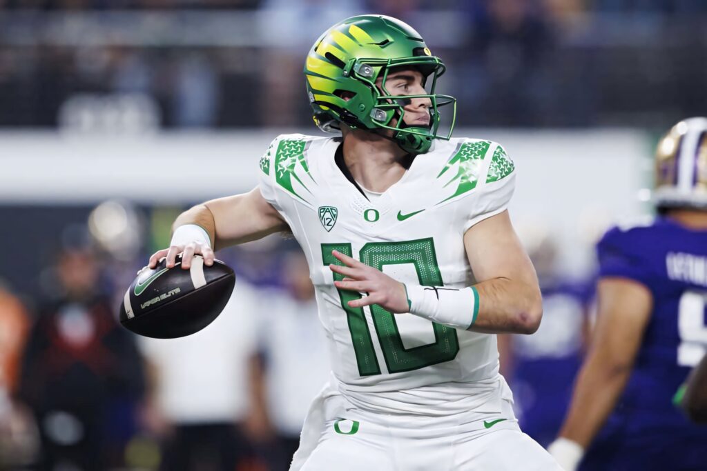 Oregon quarterback Bo Nix in white green Ducks uniform focused pre throw football pose wallpaper