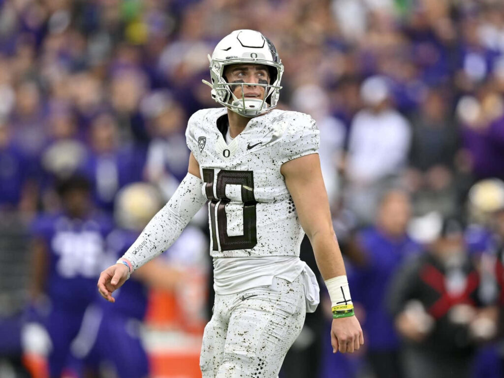 Quarterback Bo Nix in action on football field showcasing focus and intense game presence wallpaper