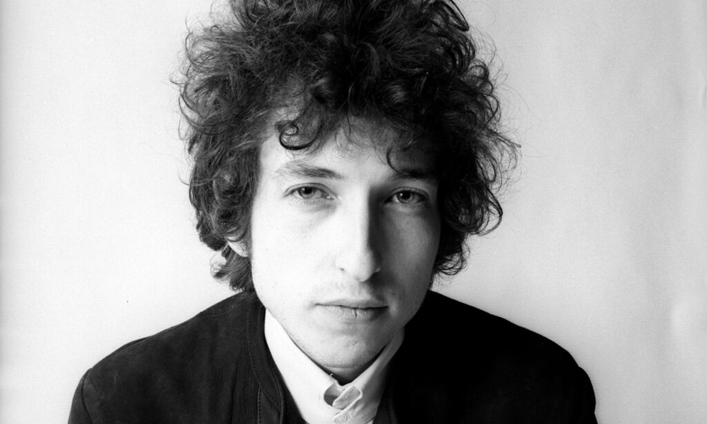Black and white portrait of Bob Dylan with intense gaze iconic style wallpaper background