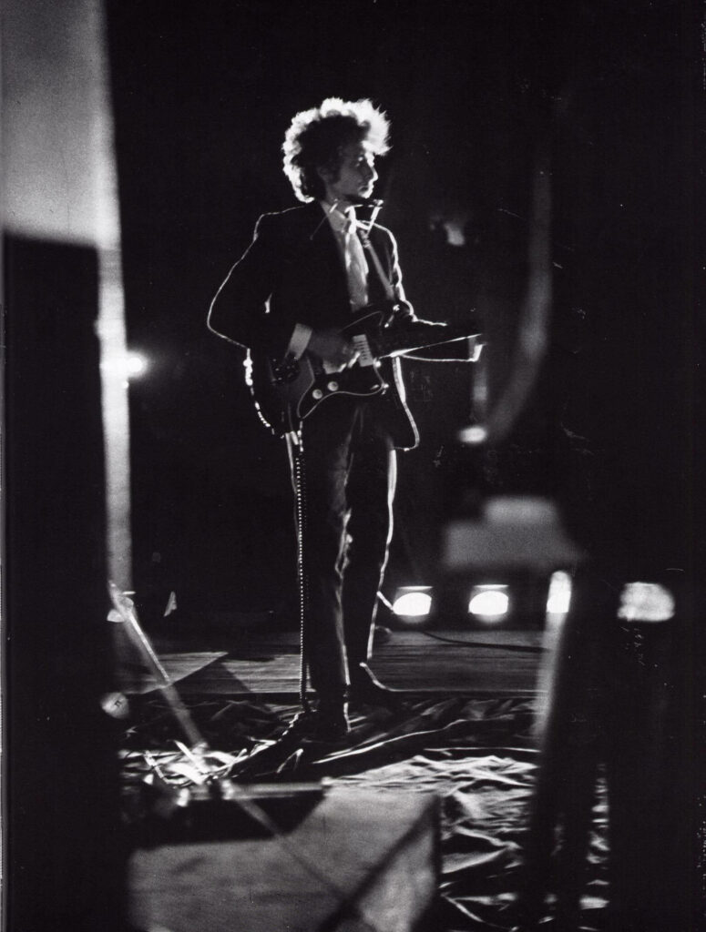 Bob Dylan performing live on stage during his iconic 1966 World Tour wallpaper background
