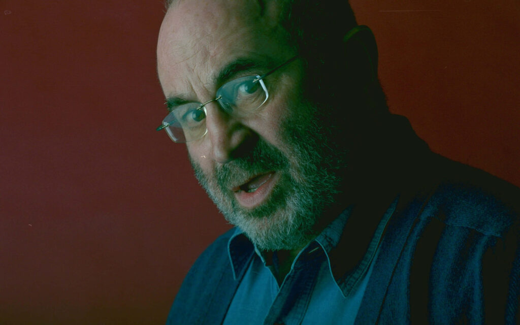 Bob Hoskins dramatic portrait with deep red background British actor wallpaper background