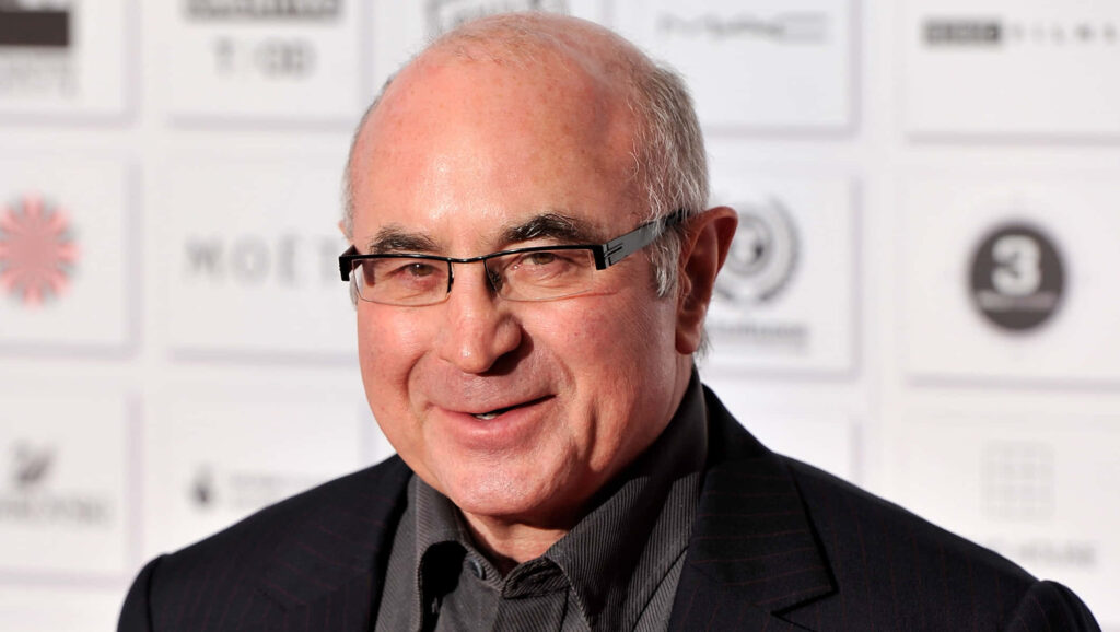 Bob Hoskins smiling warmly with event sponsor logos background wallpaper image