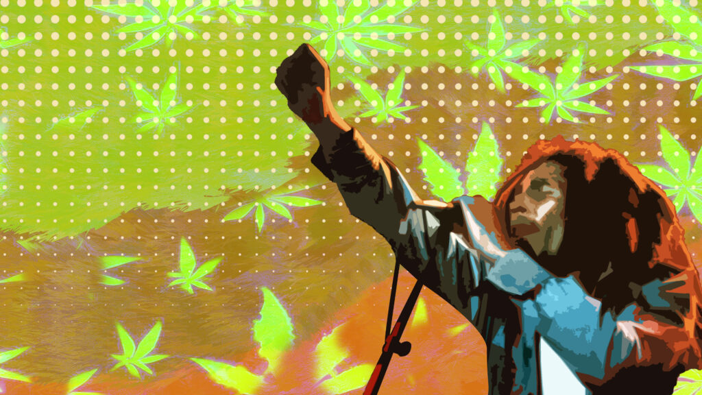 Bob Marley on stage fist raised colorful marijuana leaves background unity freedom wallpaper
