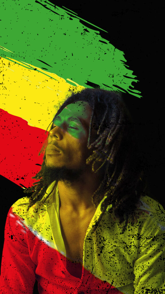 Bob Marley thoughtful portrait with Rastafarian green yellow red brush strokes on black background Wallpaper
