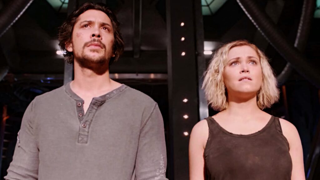 Bob Morley and Eliza Taylor from The 100 pose in industrial setting with intense lighting and hope Wallpaper