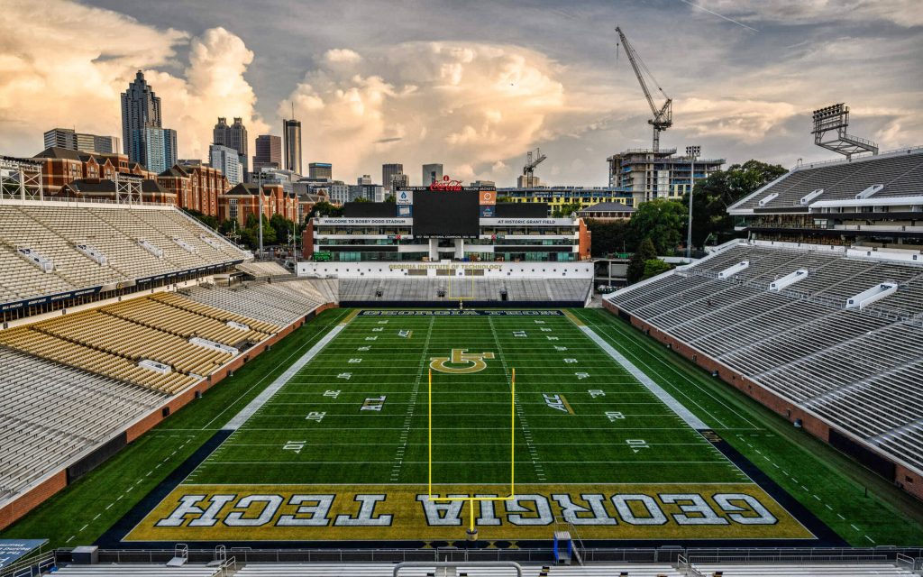 Bobby Dodd Stadium panoramic view at golden hour with lush Grant Field and Atlanta skyline Wallpaper