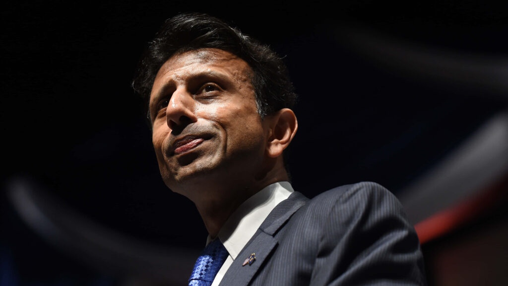 Bobby Jindal in suit looking confident profile dramatic lighting dark background wallpaper