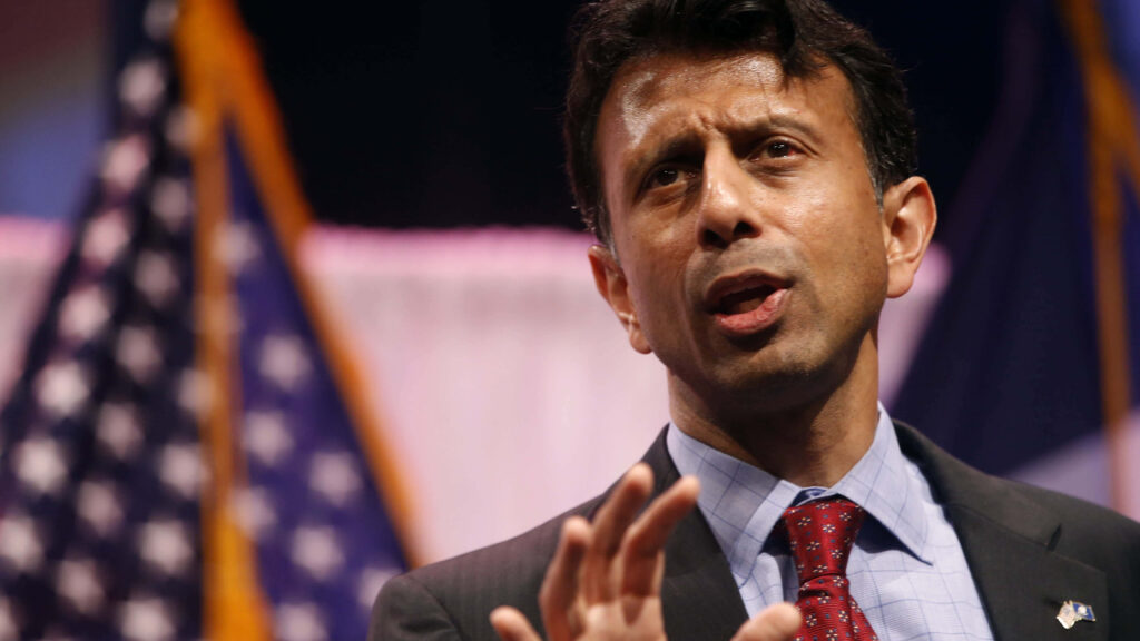 Bobby Jindal speaking with US flags backdrop patriotic leadership wallpaper background