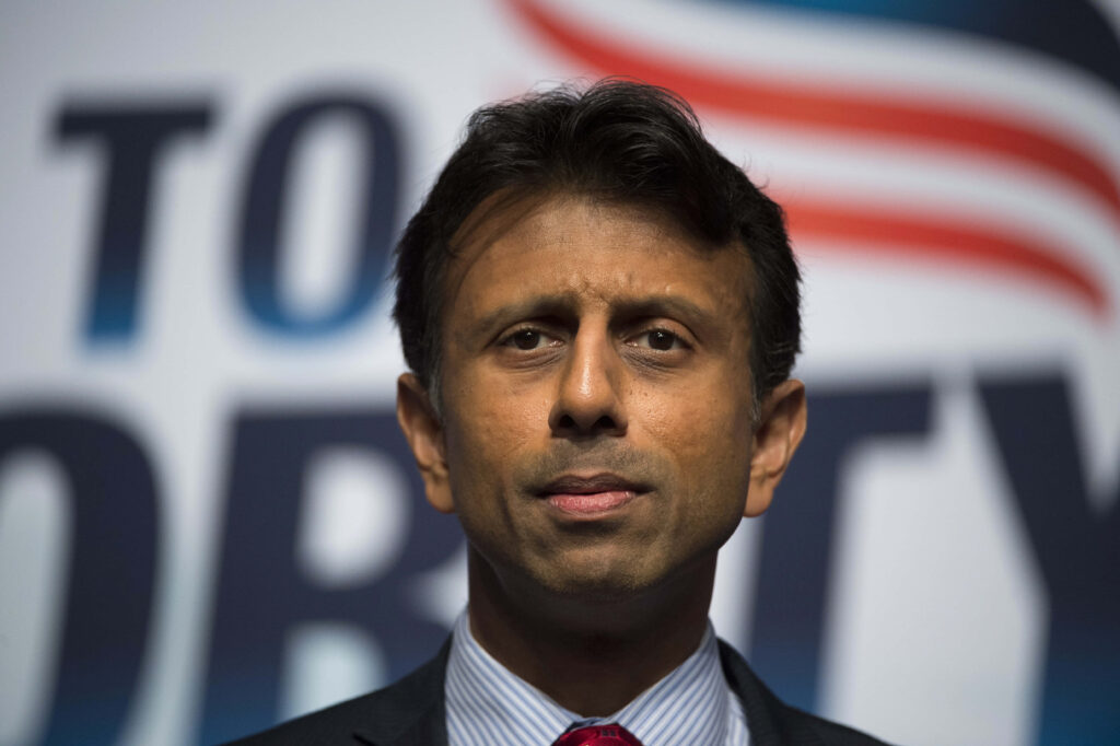 Bobby Jindal thoughtful portrait with bold wallpaper background reflecting focus and reflection