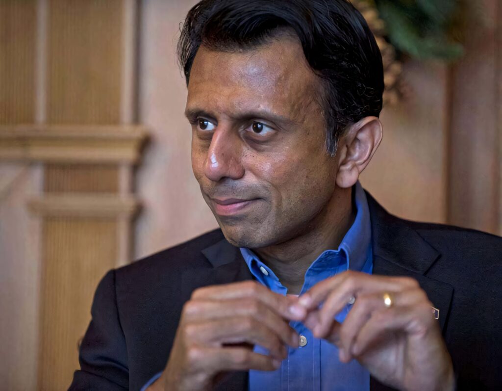 Bobby Jindal in suit with focused expression thoughtfully holding fingers wallpaper background