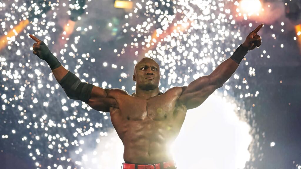 Bobby Lashley victorious with arms raised fireworks bursting dynamic wrestling wallpaper background