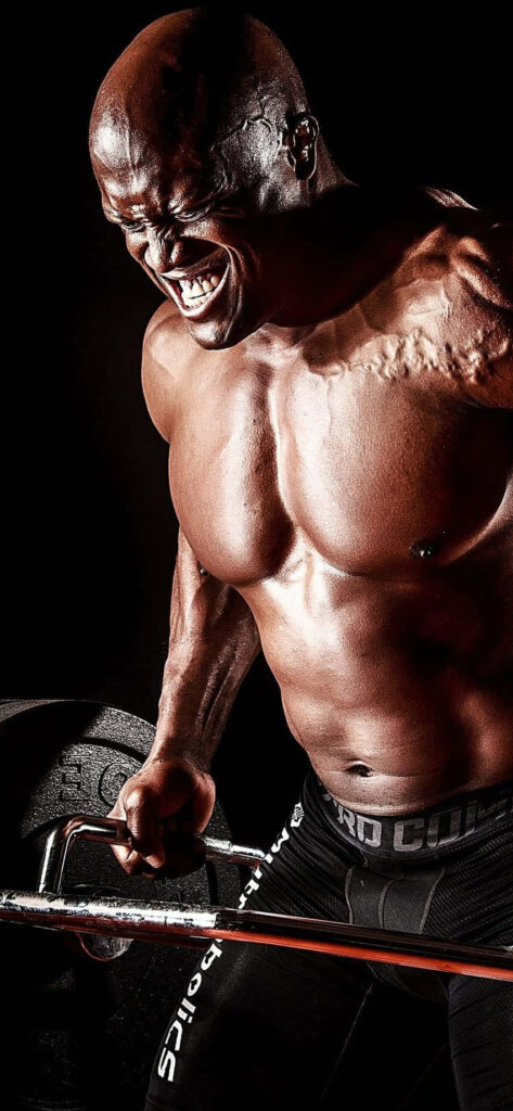 Bobby Lashley lifting heavy weights showing intense strength powerful physique and focus background Wallpaper