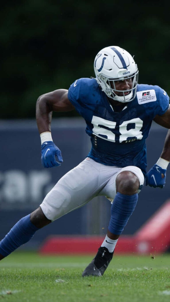 Bobby Okereke intense action Colts uniform football player showcasing focus and athleticism Wallpaper