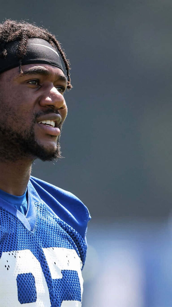 Bobby Okereke smiling in Indianapolis Colts uniform during practice showing confidence on field Wallpaper