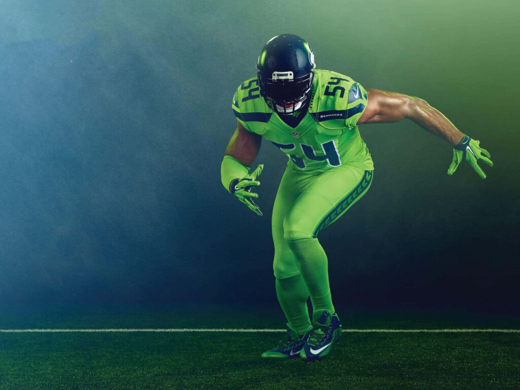 Bobby Wagner linebacker action pose dynamic wallpaper showcasing athleticism on football field