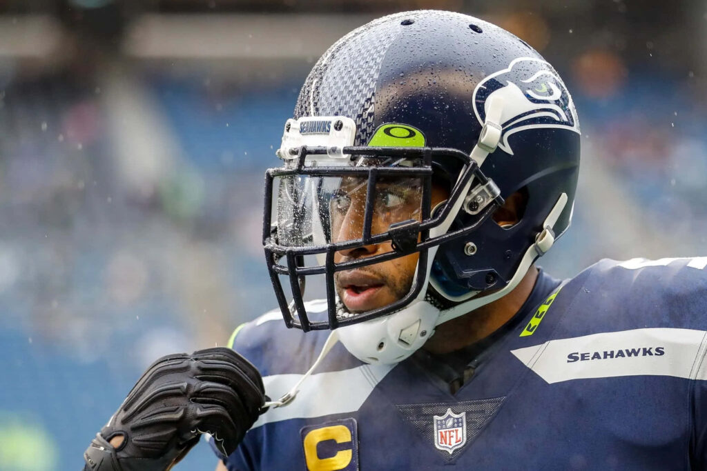 Bobby Wagner focused on rainy football field intense game wallpaper background image