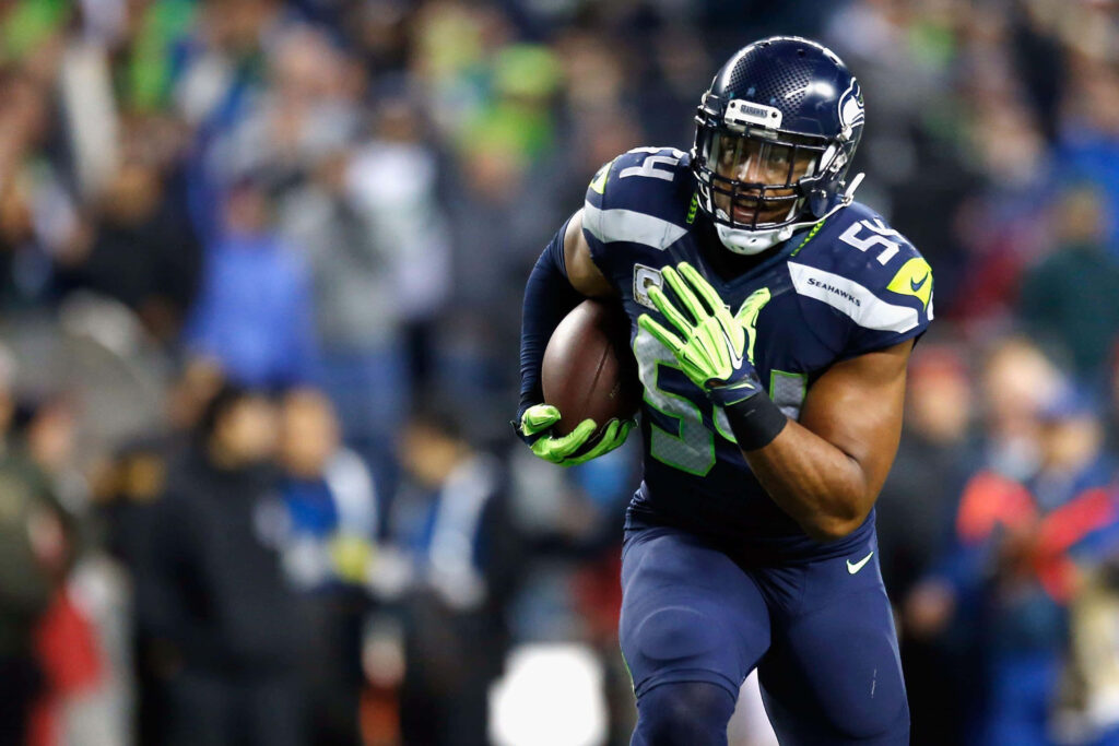 Bobby Wagner linebacker intense action football dynamic wallpaper background showing athleticism