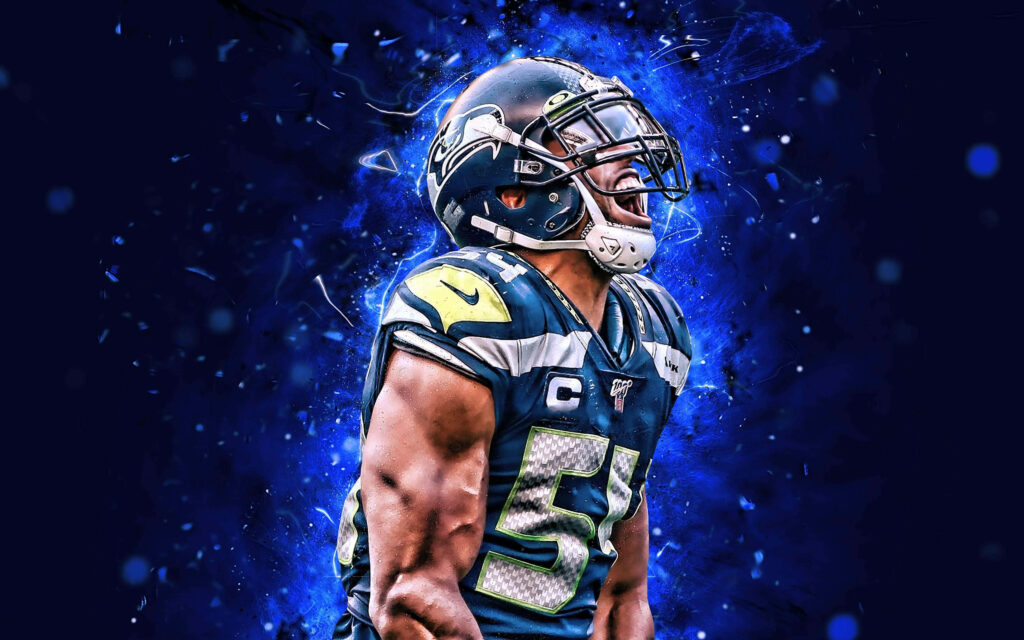 Bobby Wagner intense football action showing energy determination on field with blue background wallpaper