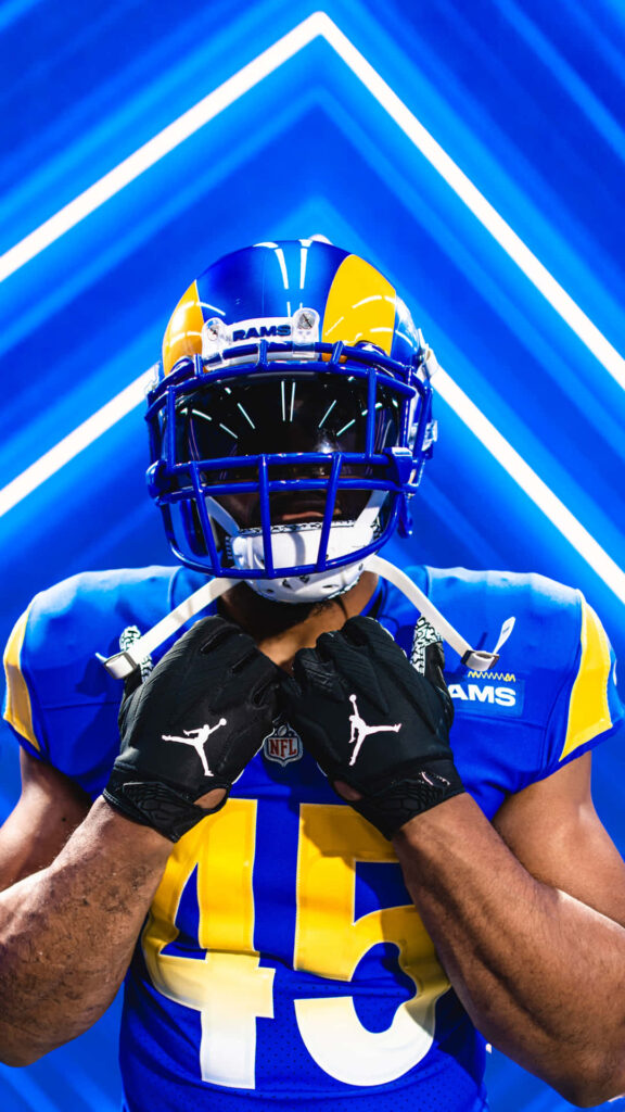 Bobby Wagner in Los Angeles Rams uniform confident fierce portrait with blue geometric background Wallpaper