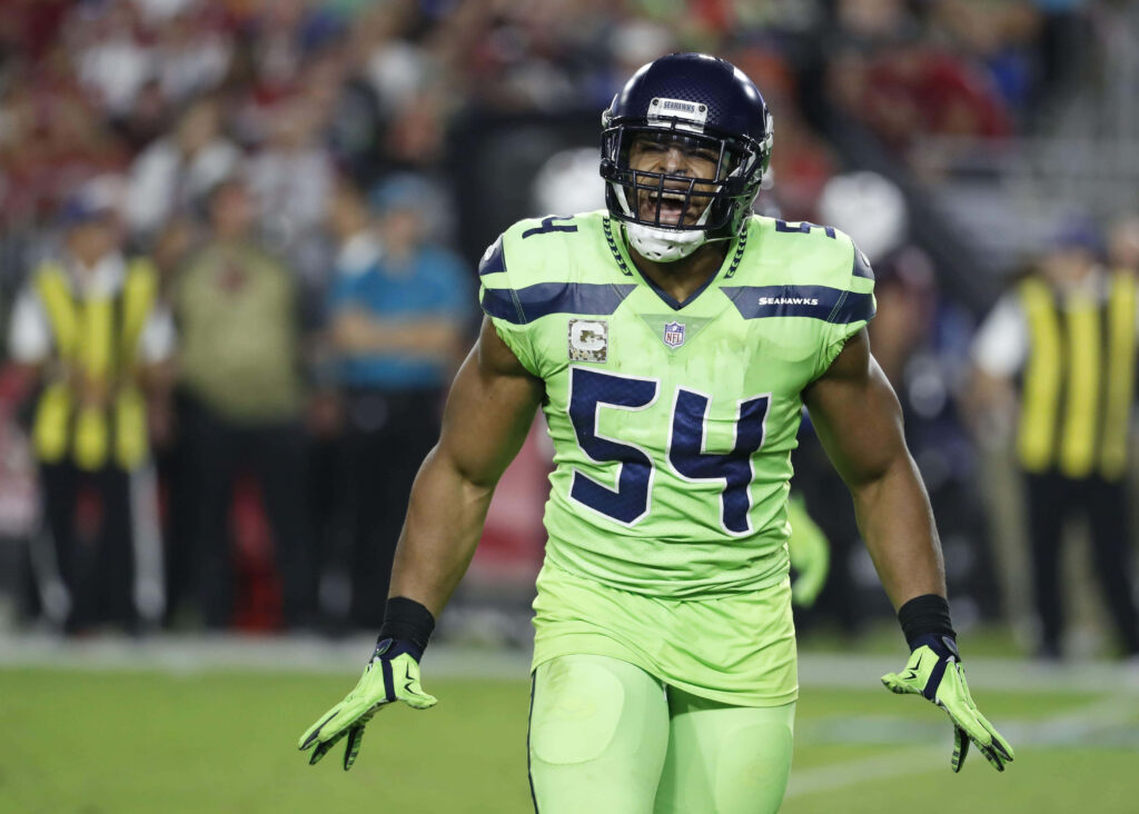 Bobby Wagner Seattle Seahawks intense mid-game action football player on field wallpaper background