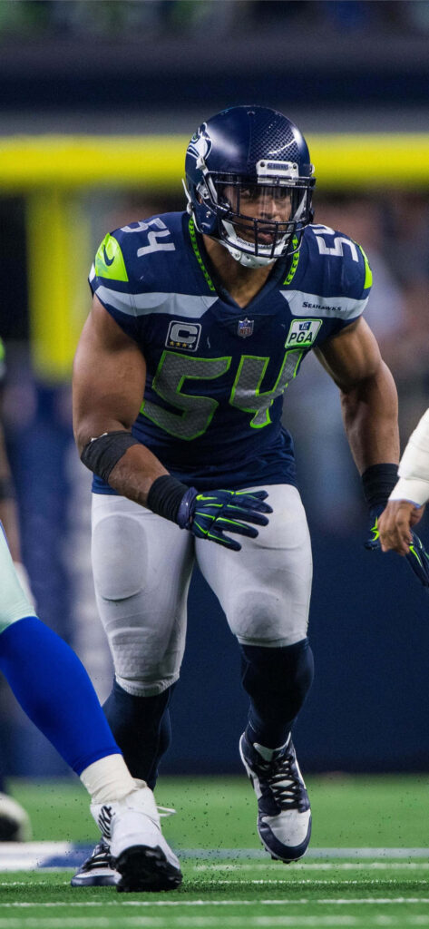 Bobby Wagner intense focus charging forward Seattle Seahawks action football wallpaper background