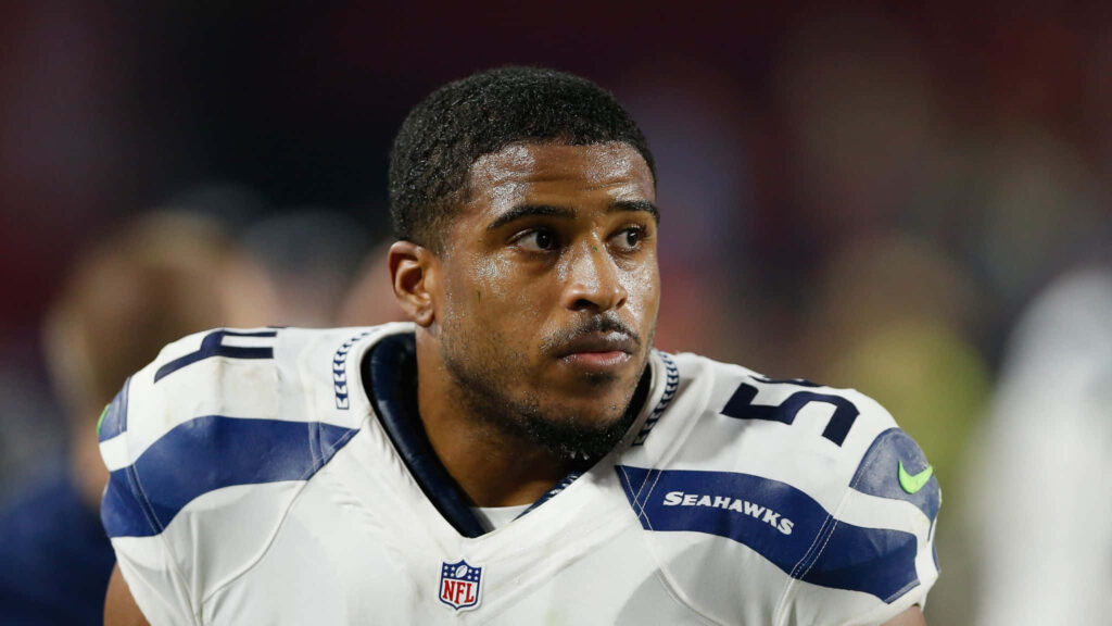 Bobby Wagner in Seattle Seahawks uniform focused on game showing determination and leadership Wallpaper