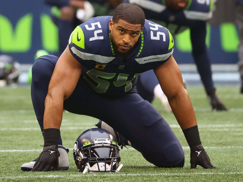 Bobby Wagner intense ready stance linebacker Seattle Seahawks on football field wallpaper background
