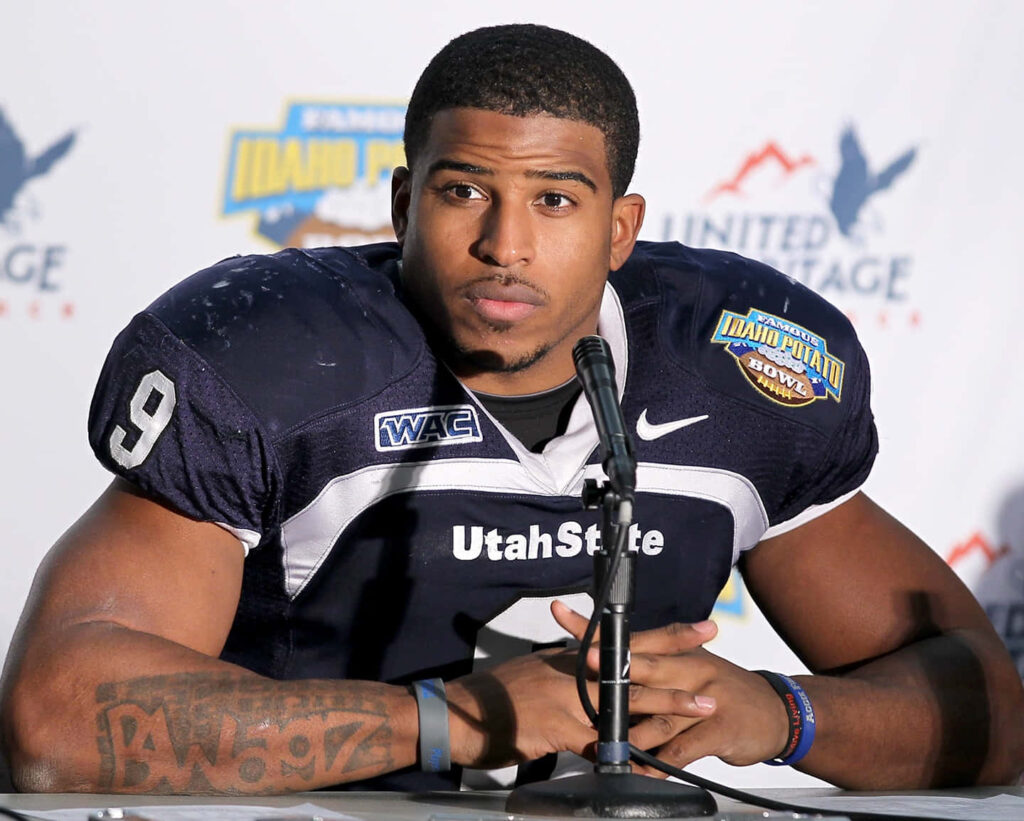 Bobby Wagner in Utah State football uniform speaking at press conference showing leadership Wallpaper