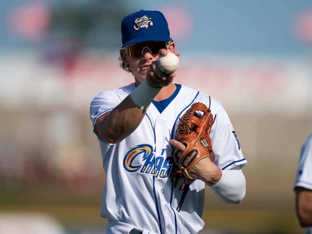 Bobby Witt Jr focused throwing baseball in team uniform on field action wallpaper background