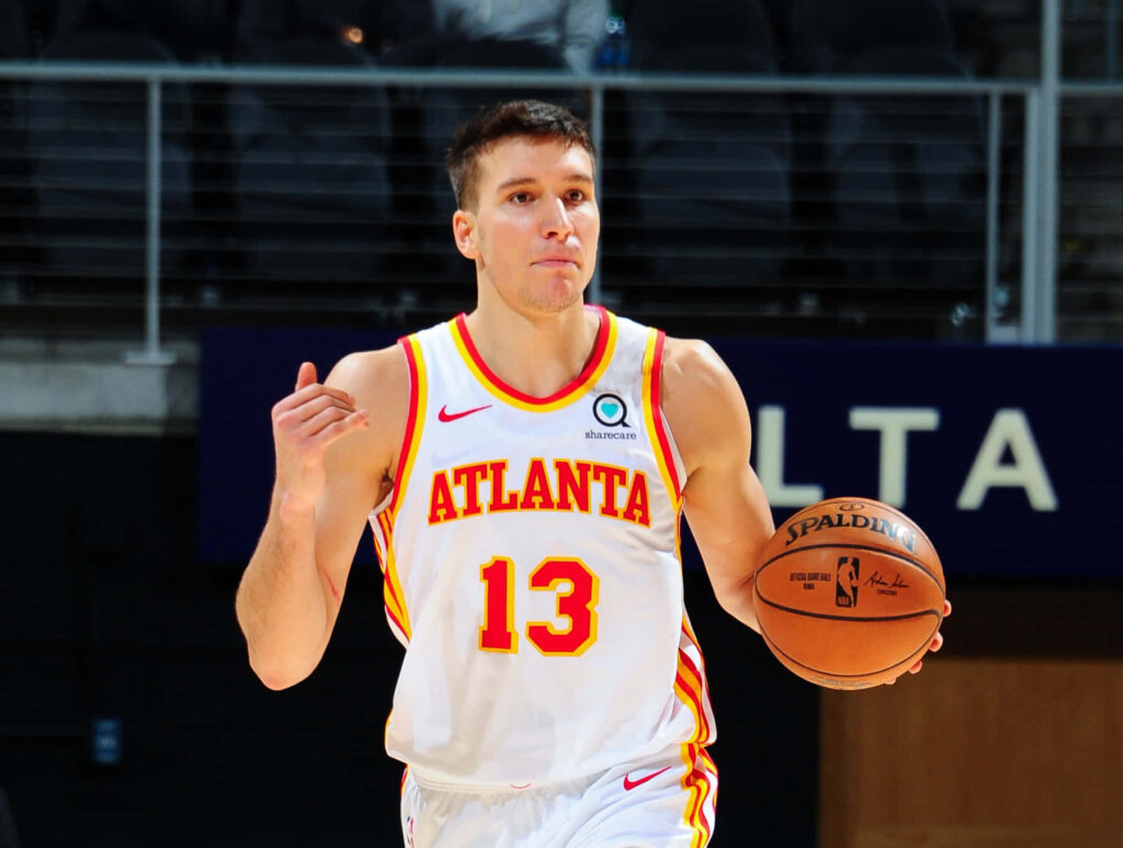 Bogdan Bogdanović in Atlanta Hawks uniform poised to play on open basketball court wallpaper background